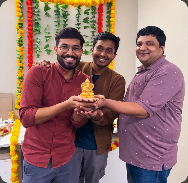 Colleagues holding a festive idol