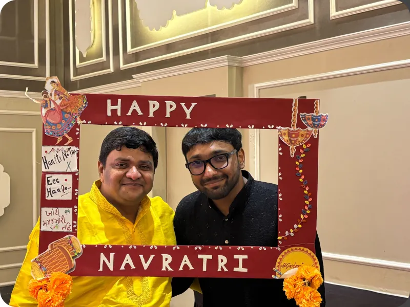 Colleagues posing in a Navratri photo frame
